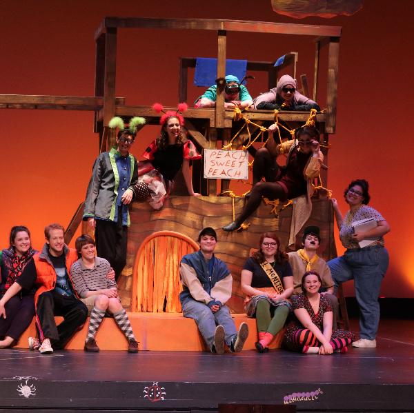 The cast of a theatre production of "James and the Giant Peach" on stage